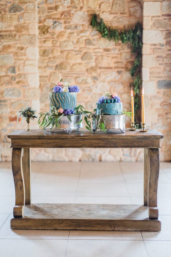 Wedding cake styled by photographer and captured against natural stone background using ambient lighting.