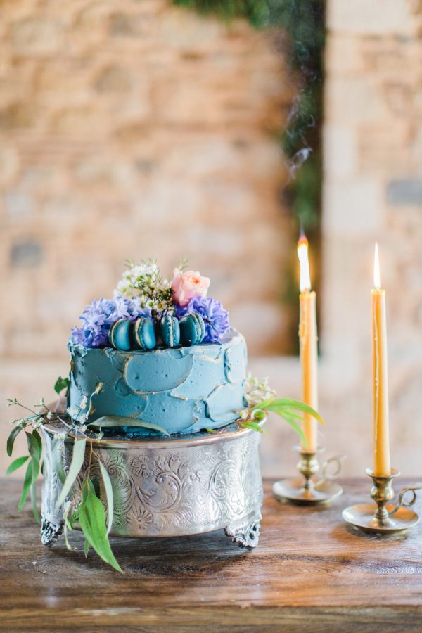 Wedding cake styled by photographer and captured against natural stone background using ambient lighting.