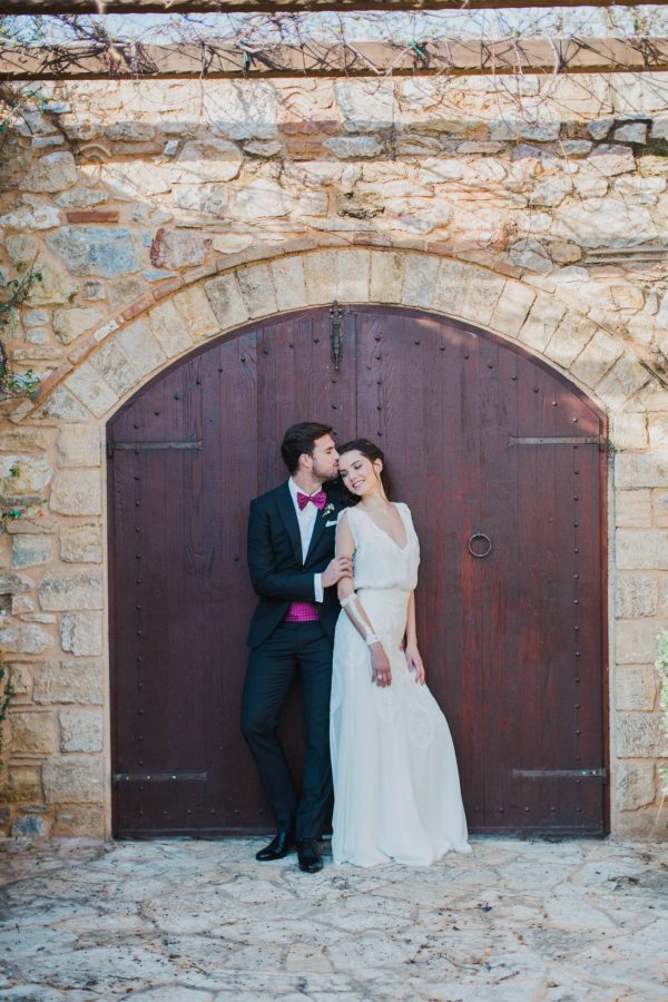 Bride and groom posing for elegant wedding day portraits with the backround of Pyrgos Petreza estate in Athens.