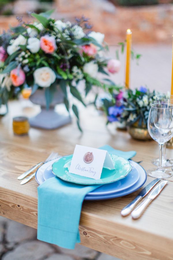 Wedding day dinner reception set up with delicate details, elegant plates, seasonal flowers and personalized place cards styled and photographed in Pyrgos Petreza Athens.