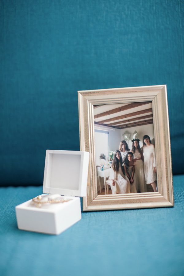 Bridesmaids' favors and a photo frame with image of the bride and her bridesmaids earlier that year when shopping for wedding dresses together.