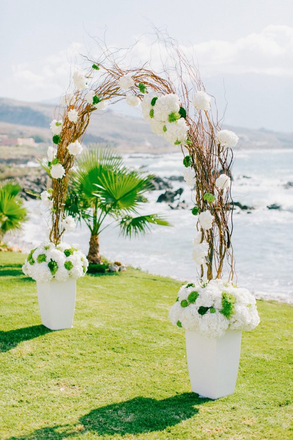 White, gold and green wedding ceremony set up in a palm tree wedding estate in Rethymno Crete.