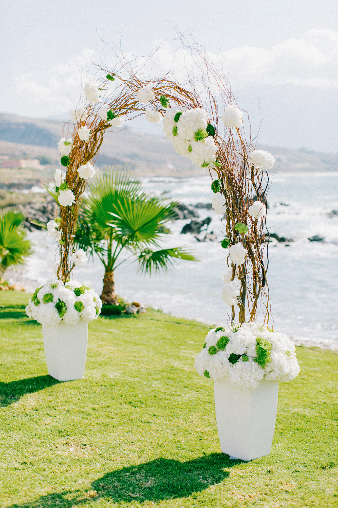 White, gold and green wedding ceremony set up in a palm tree wedding estate in Rethymno Crete.