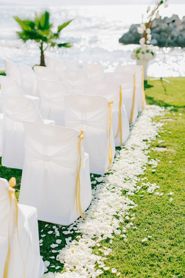 White, gold and green wedding ceremony set up in a palm tree wedding estate in Rethymno Crete.