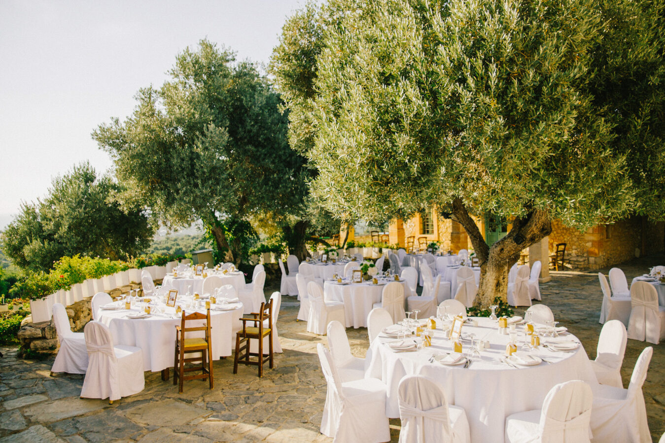 Detail of luxury elegant dinner reception set up in green, white and gold at Grecotel Agreco wedding estate in Crete captured before the arrival of guests and the grand entrance.