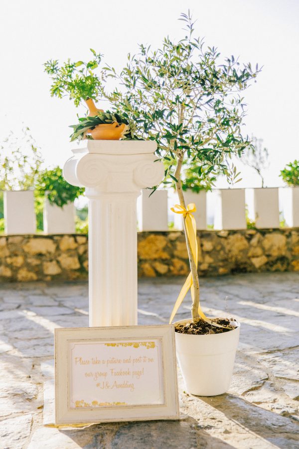 Detail of luxury elegant dinner reception set up in green, white and gold at Grecotel Agreco wedding estate in Crete captured before the arrival of guests and the grand entrance.