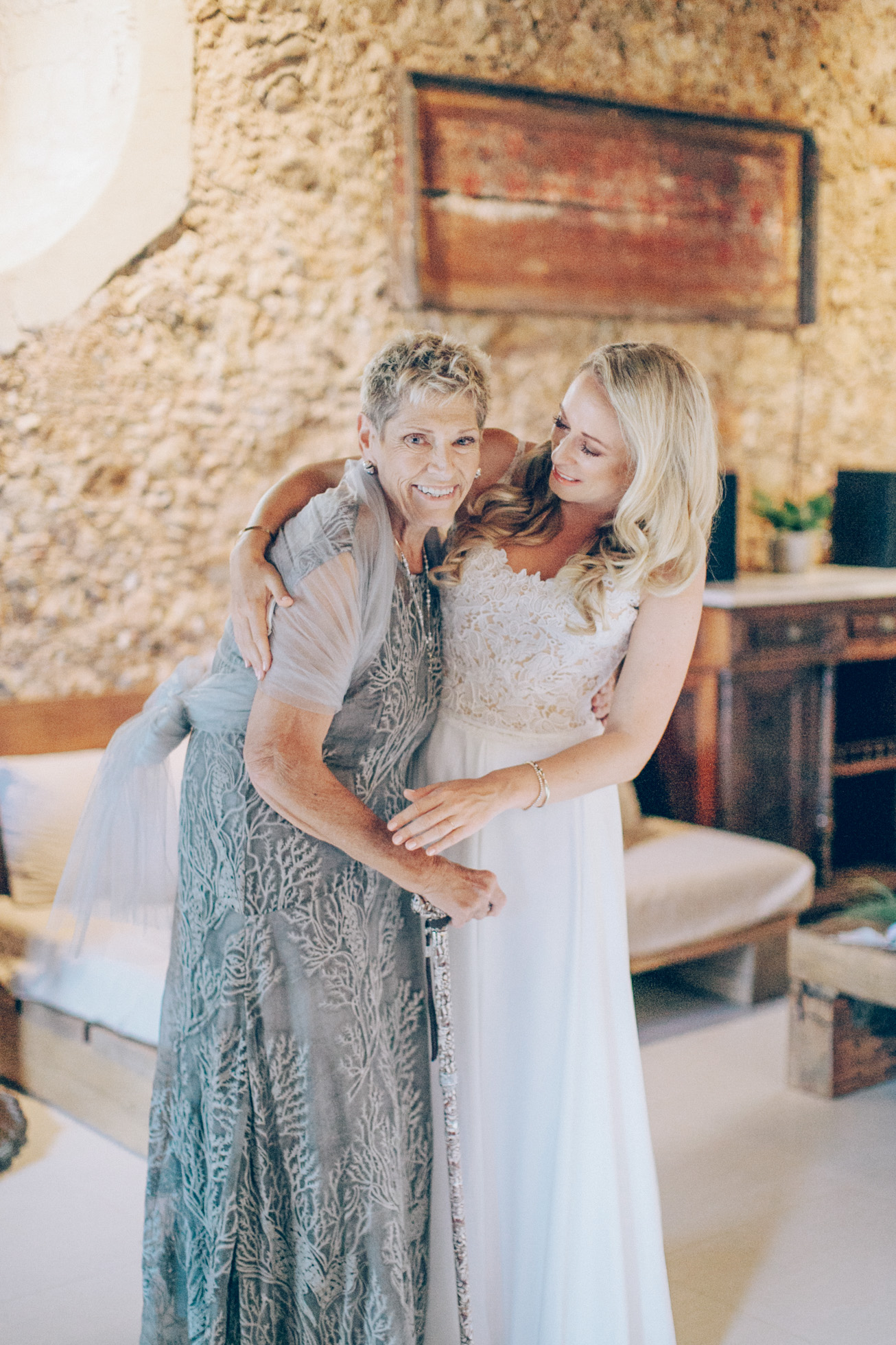 Beautiful bride with her mother posing for the wedding photographer on a summer wedding day in Chania, Crete.