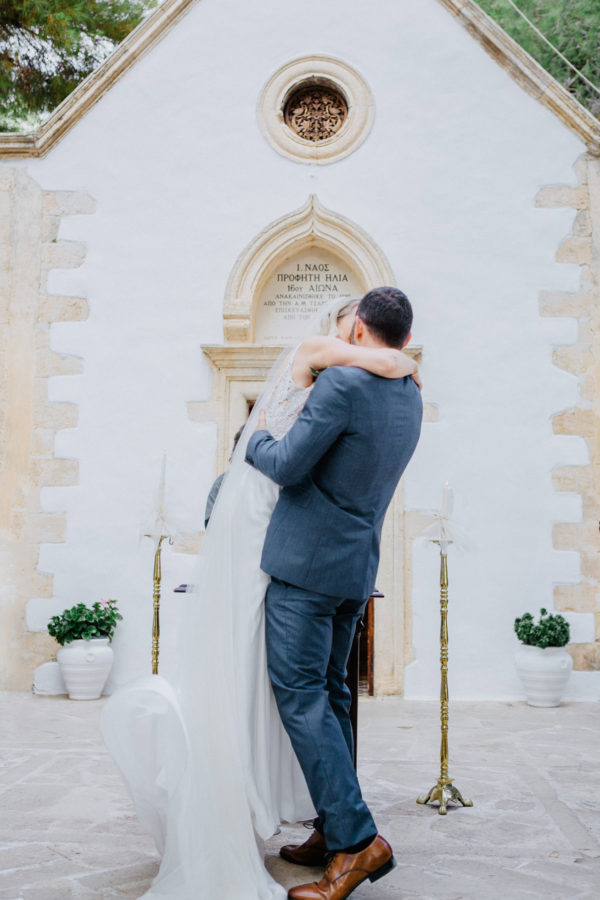 Beautiful bride and groom posing for wedding day portraits in Profitis Ilias, Crete island, Greece.
