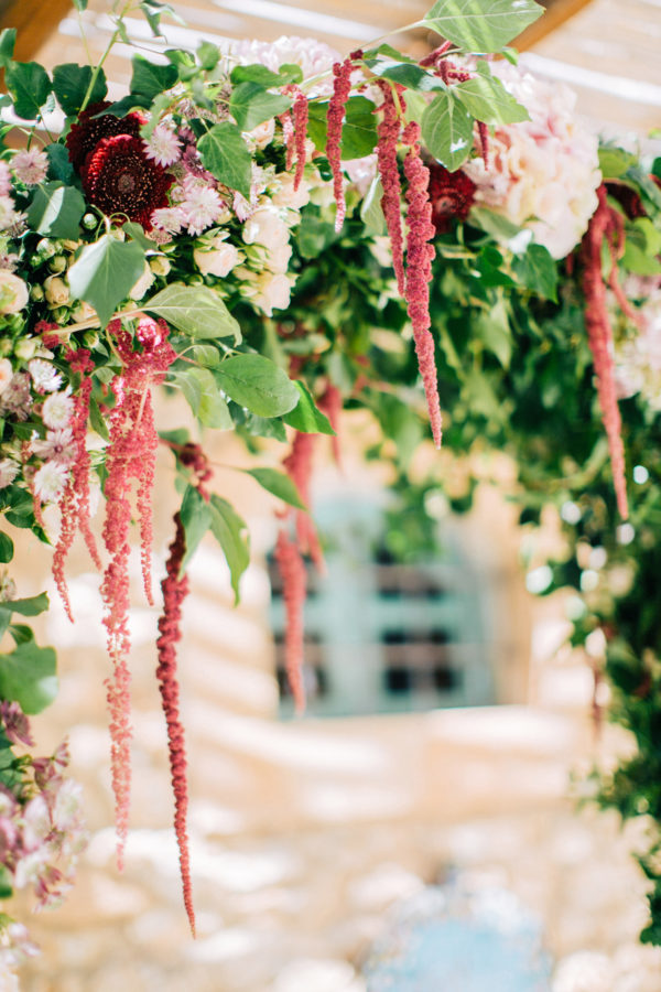 Rich floral decorations and details created by Fabio Zardi and captured by wedding photographer during a destination wedding in Agreco farm in Crete.