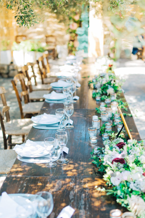 Rich dinner reception table settup and details created by Fabio Zardi and captured by wedding photographer during a destination wedding in Agreco farm in Crete.