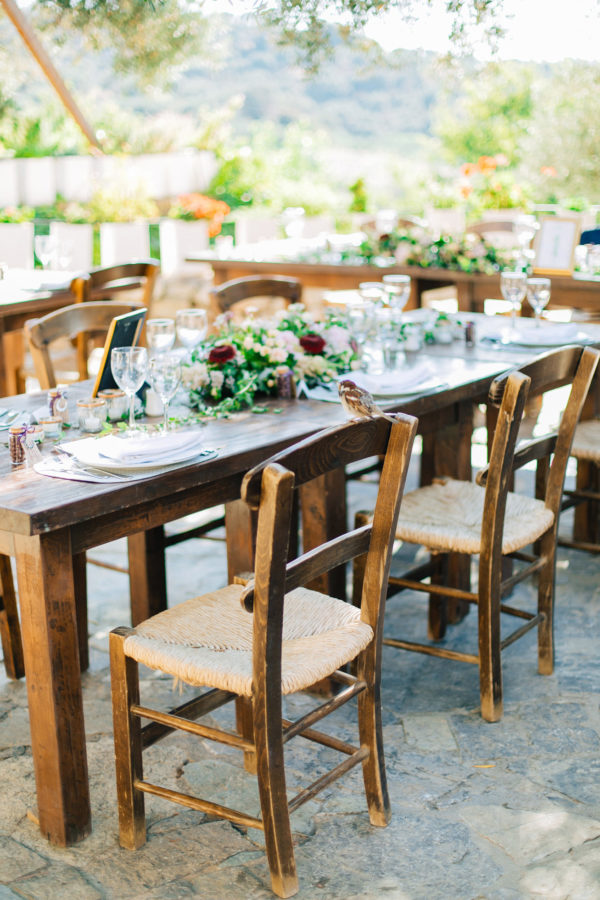 Rich dinner reception table settup and details created by Fabio Zardi and captured by wedding photographer during a destination wedding in Agreco farm in Crete.