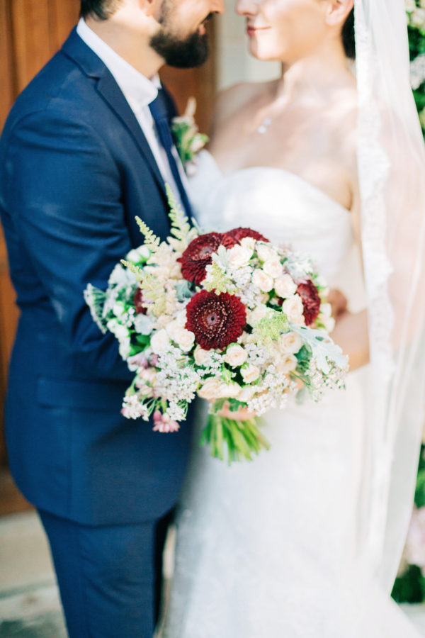 Stunning and happy bride and groom posing for portraits for their photographer on a destination wedding day in Agreco Farm, Crete.