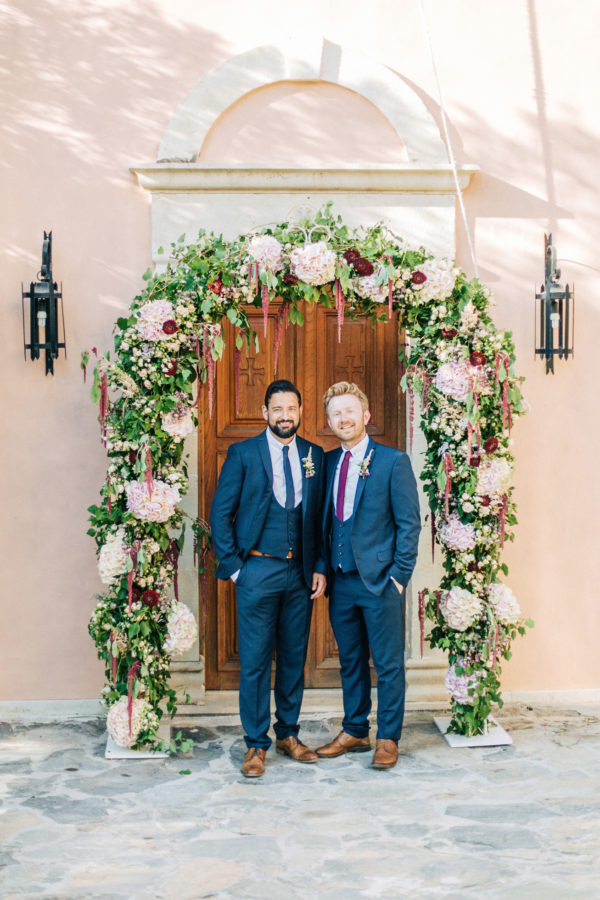 Trendy groom and his classy best man posing for formal portraits after the wedding ceremony at Agreco Farm in Crete, Greece.