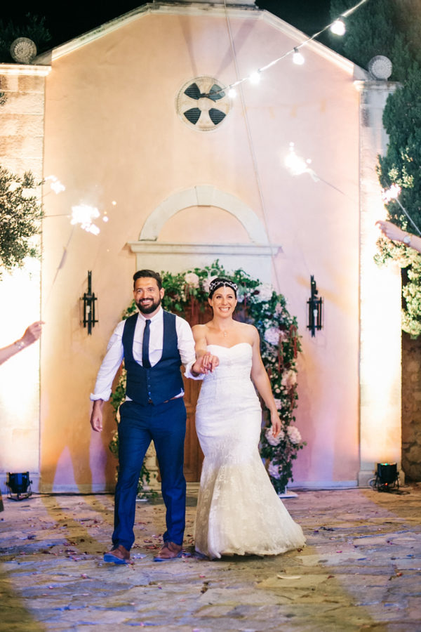 Candid evening images of bride and groom at their sparkler lit wedding reception in Agreco Farm, Crete, Greece.