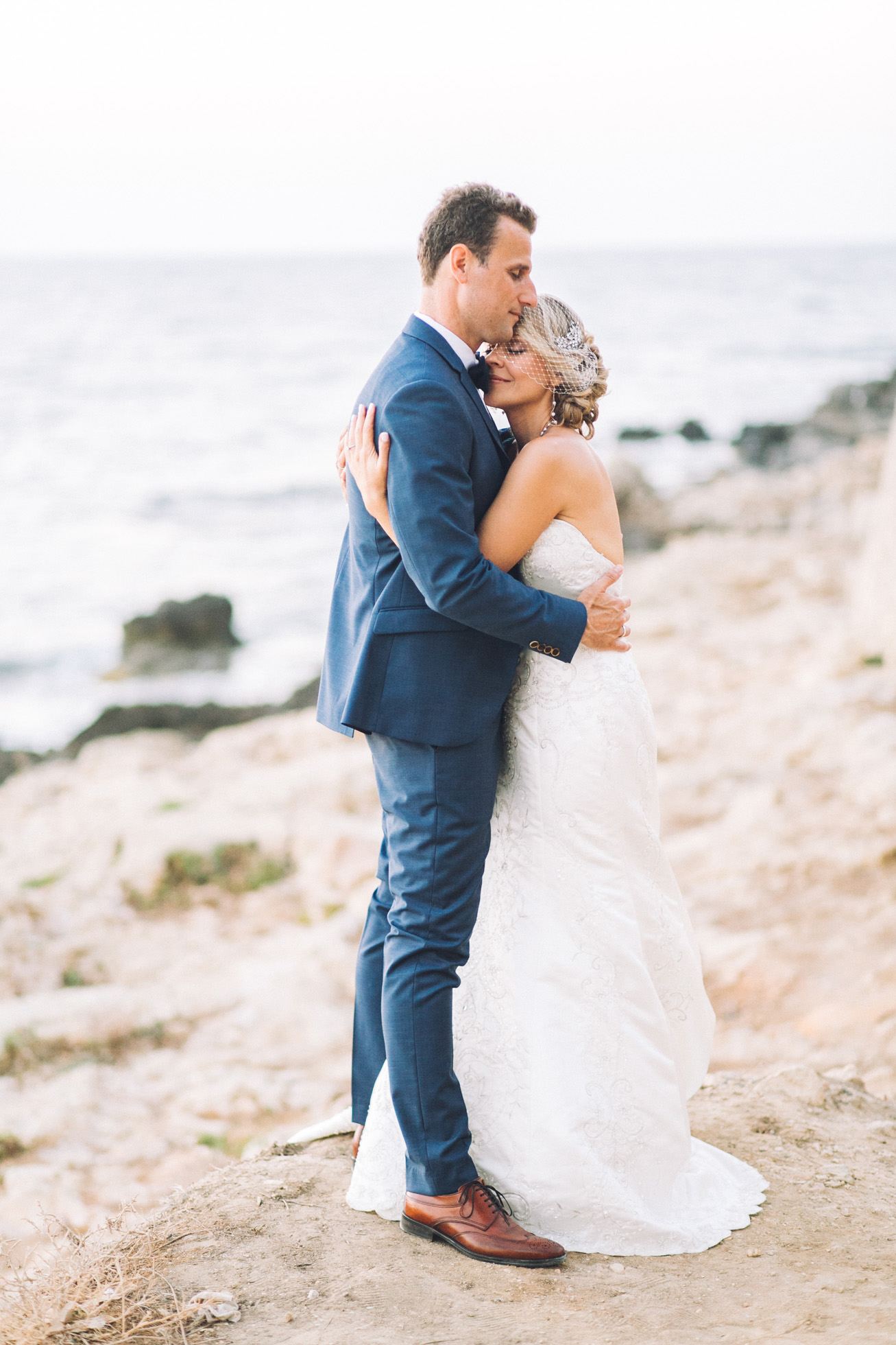 Just married! Elegant bride and groom posing for portraits on their destination wedding day in Crete island, Greece.