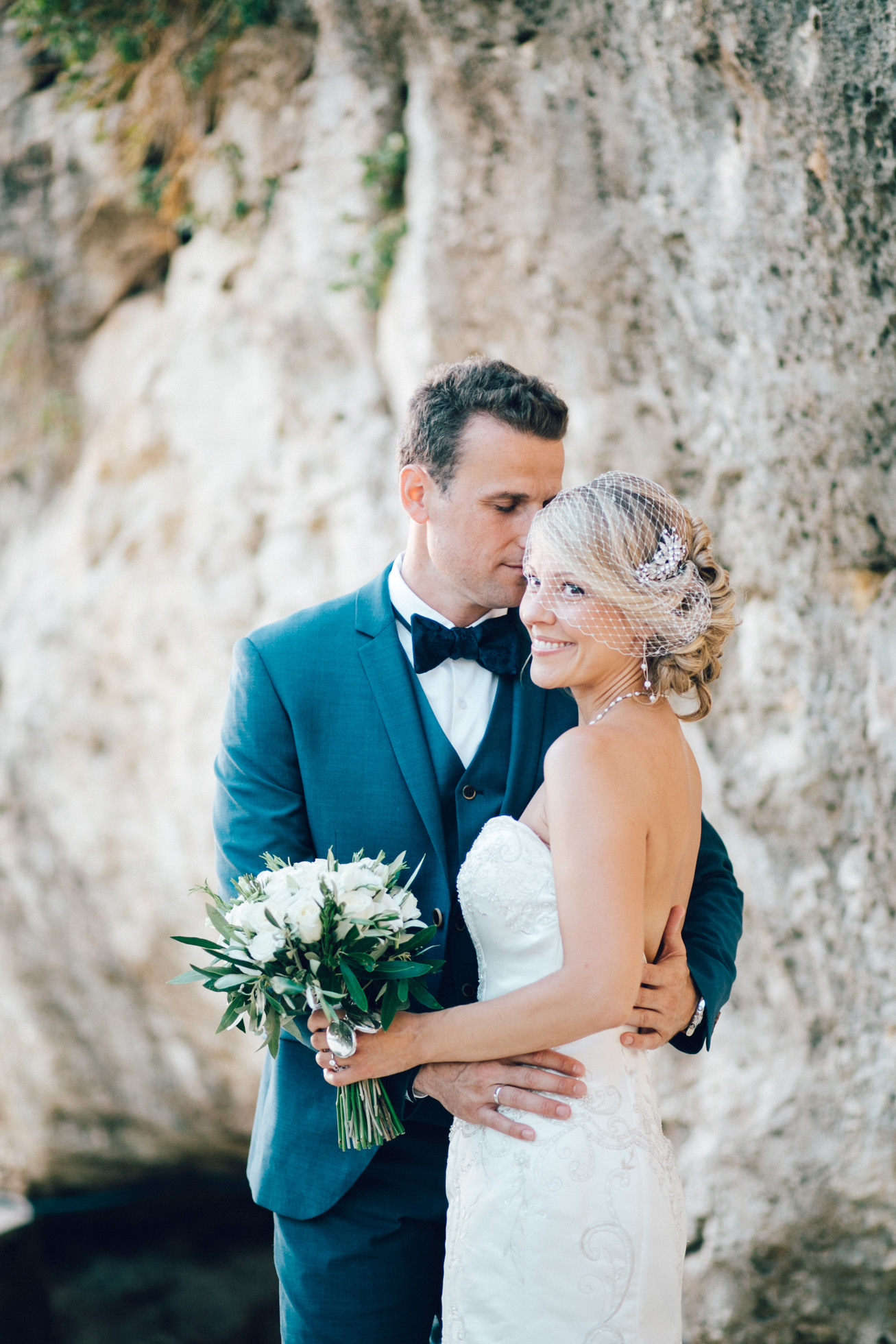 Just married! Elegant bride and groom posing for portraits on their destination wedding day in Crete island, Greece.