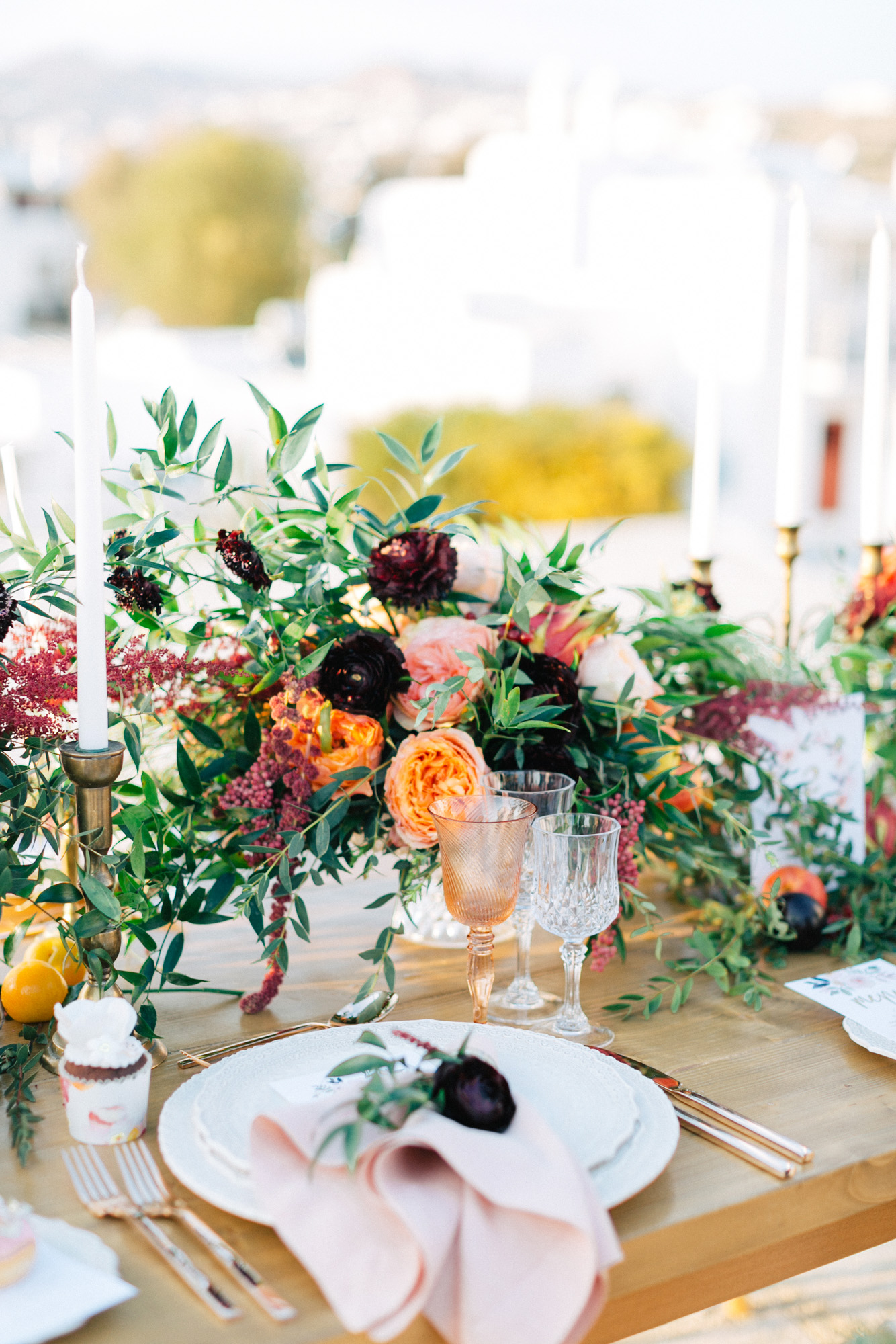 Rich and colorful table setting and flowers for a destination wedding in Mykonos, Greece.