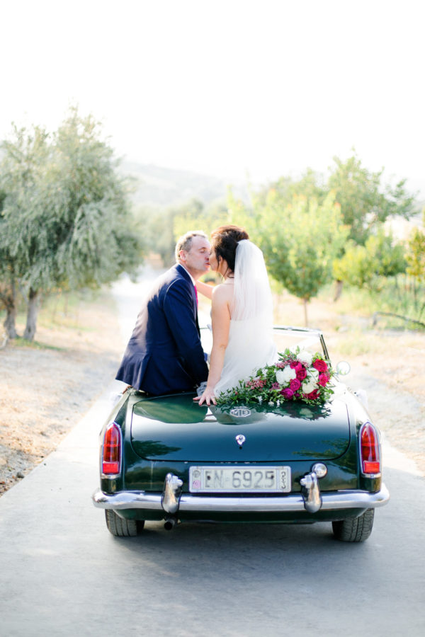 Elegant newlywed couple posing for portraits on their wedding day in Crete.