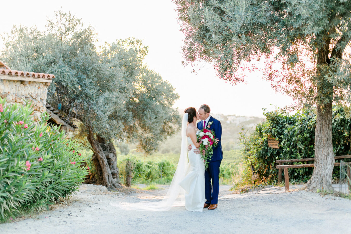 Elegant newlywed couple posing for portraits on their wedding day in Crete.