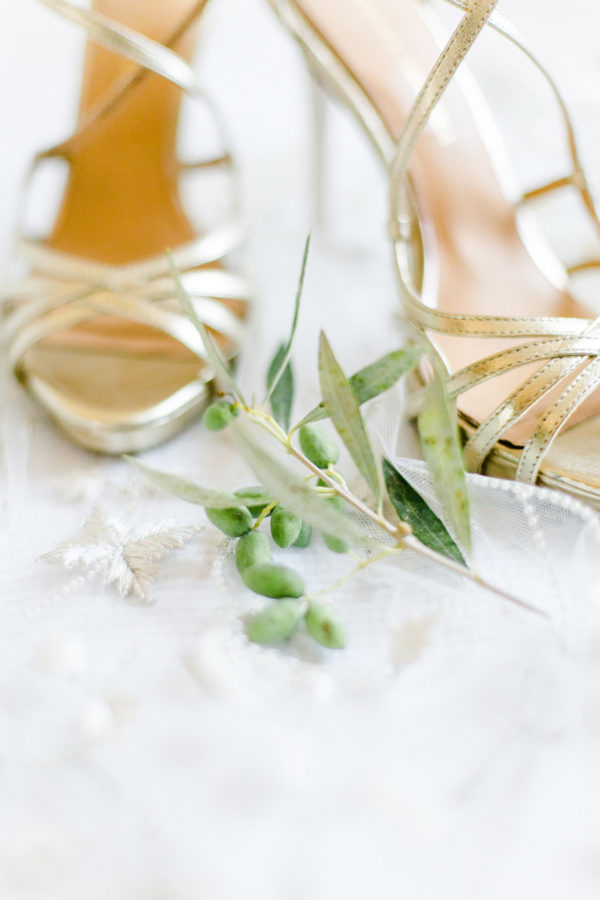 Badgley Mischka bridal shoes styled with olive branch over a Lazaro bridal veil.
