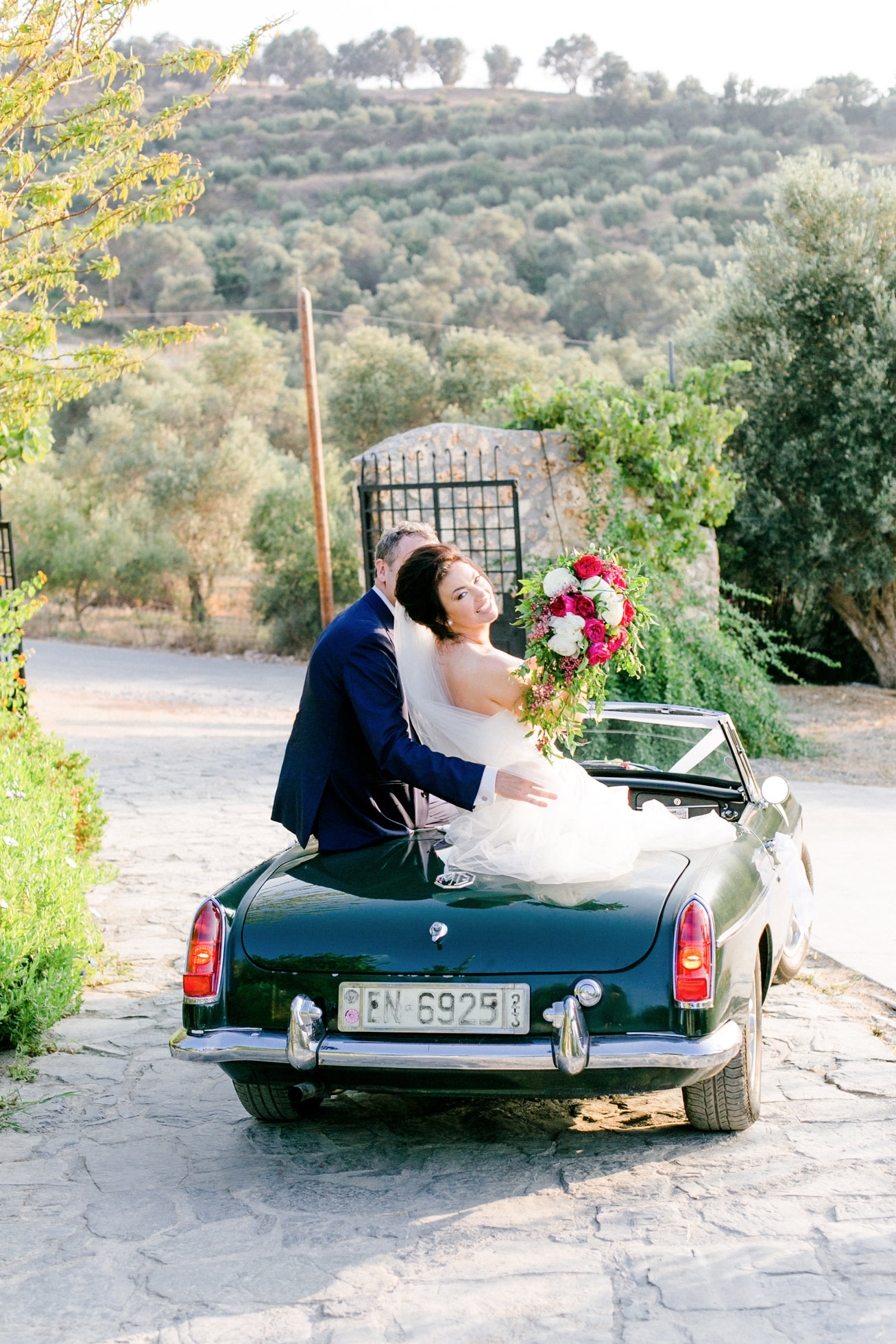 Elegant newlywed couple posing for portraits on their wedding day in Crete.