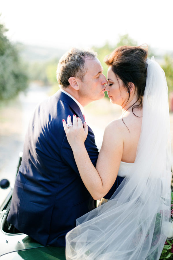 Elegant newlywed couple posing for portraits on their wedding day in Crete.