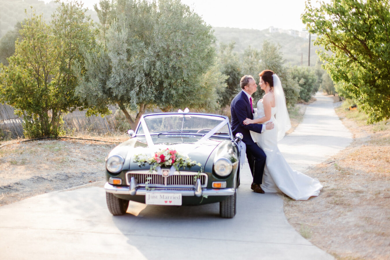 Elegant newlywed couple posing for portraits on their wedding day in Crete.