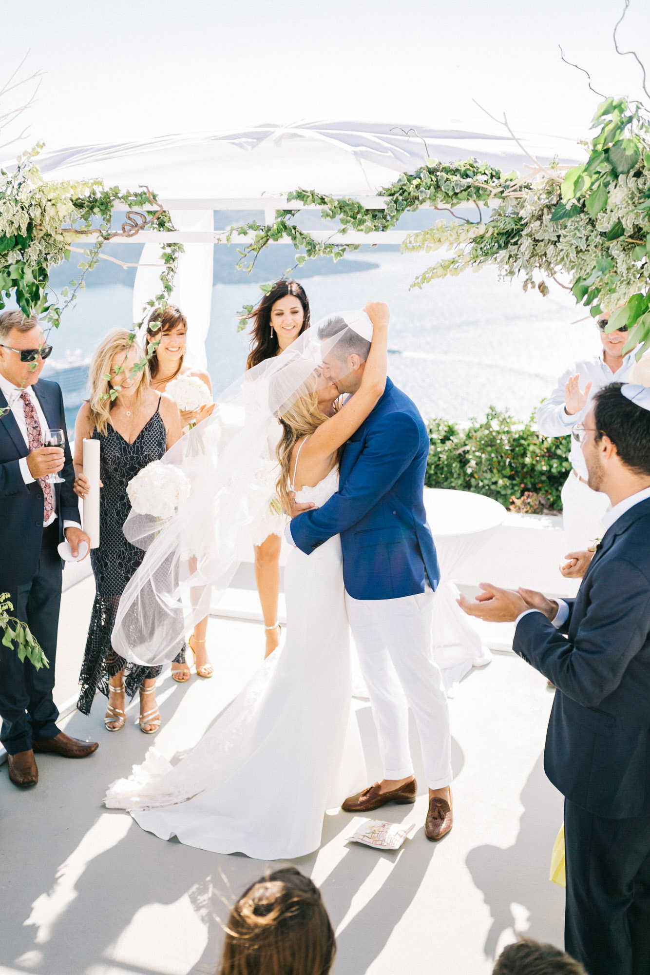 First kiss over Santorini caldera wedding.