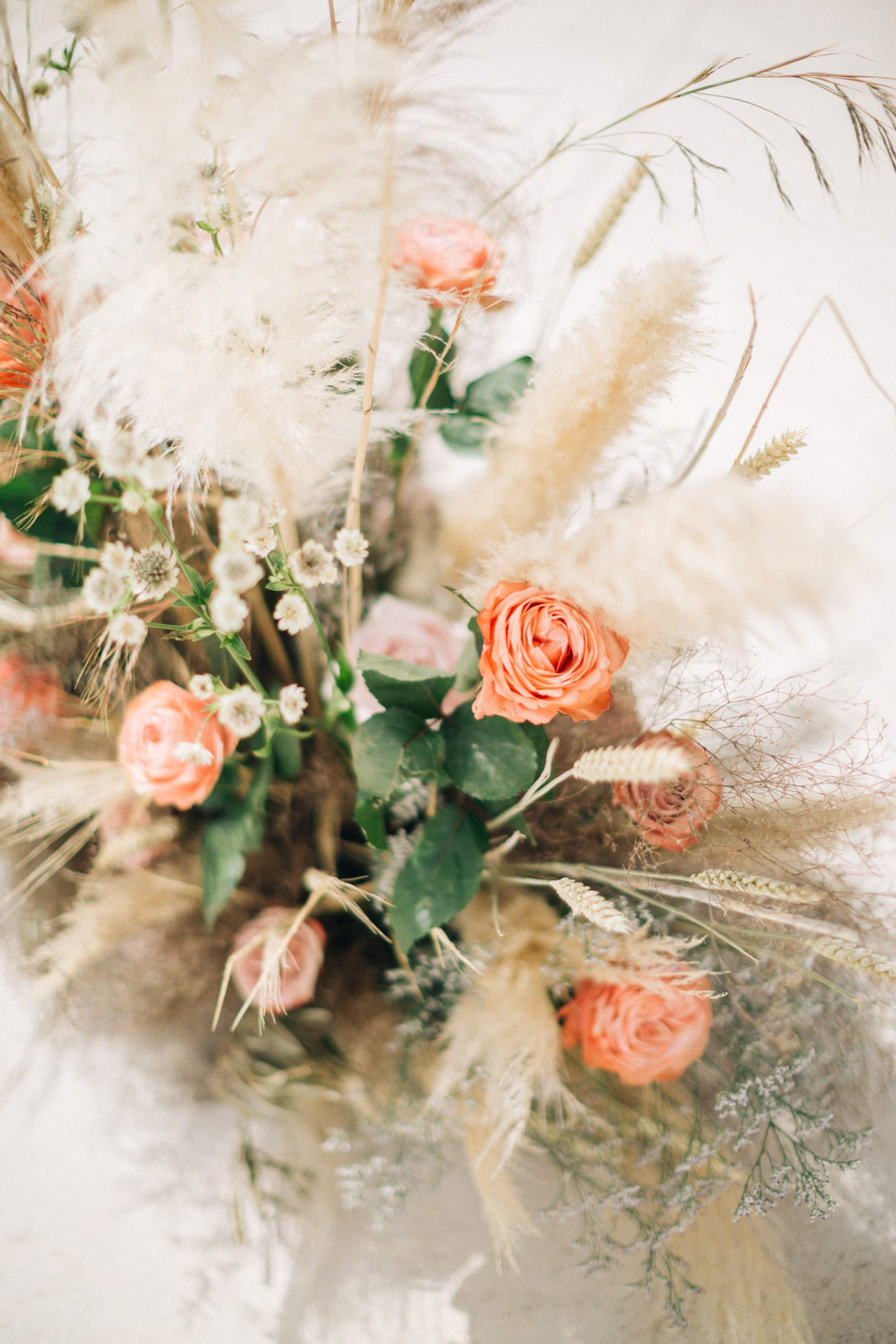 Elegant and romantic floral wedding decoration in peach and merigold in Santorini.