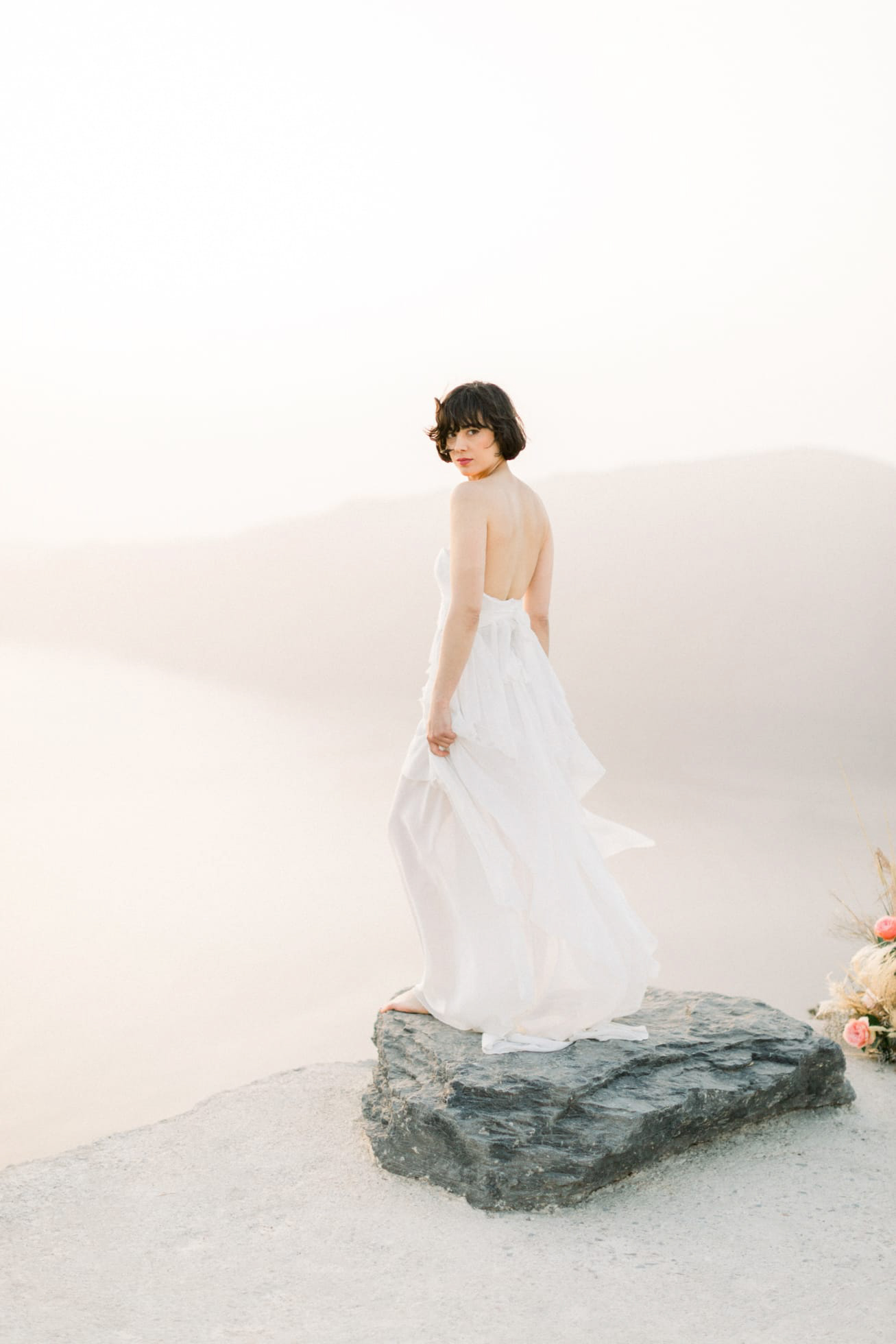 Dreamy and poetic Santorini bride wearing flowy designer wedding dress and diamond theme coordinated jewellery.
