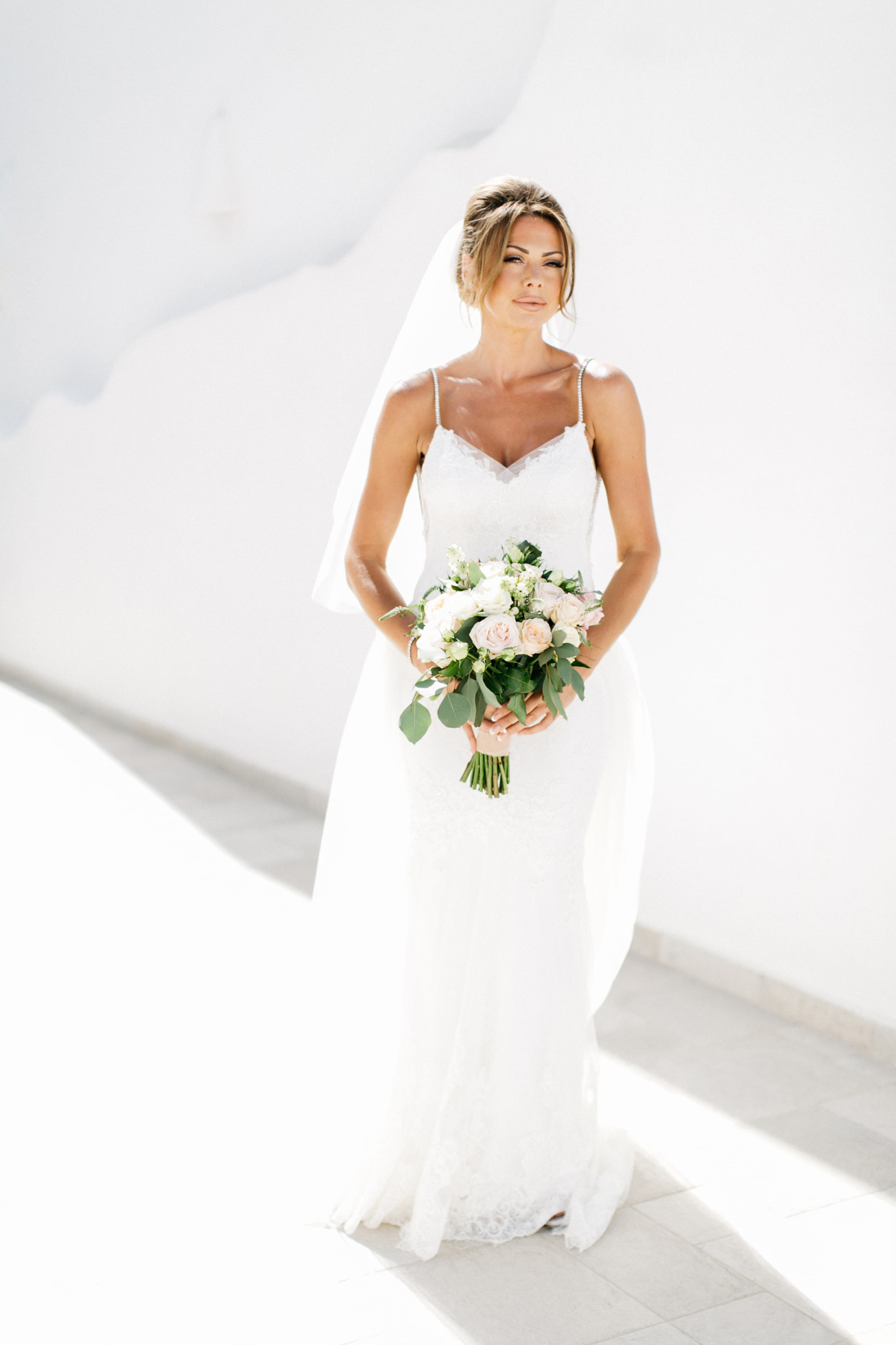 Bride's portrait before wedding ceremony in Santorini island, Greece.