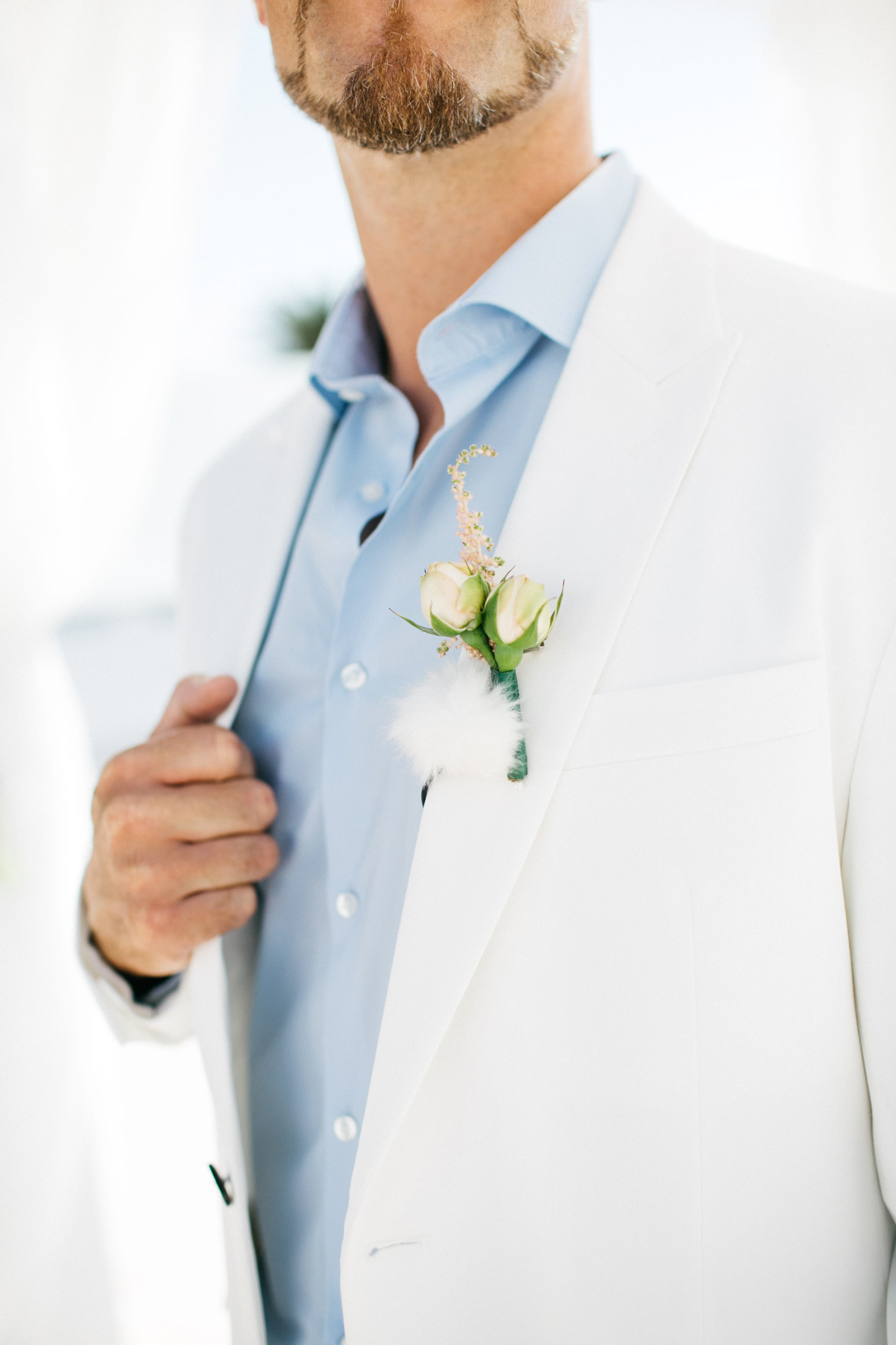 Groom's boutoniere for luxury white wedding in Santorini island, Greece.