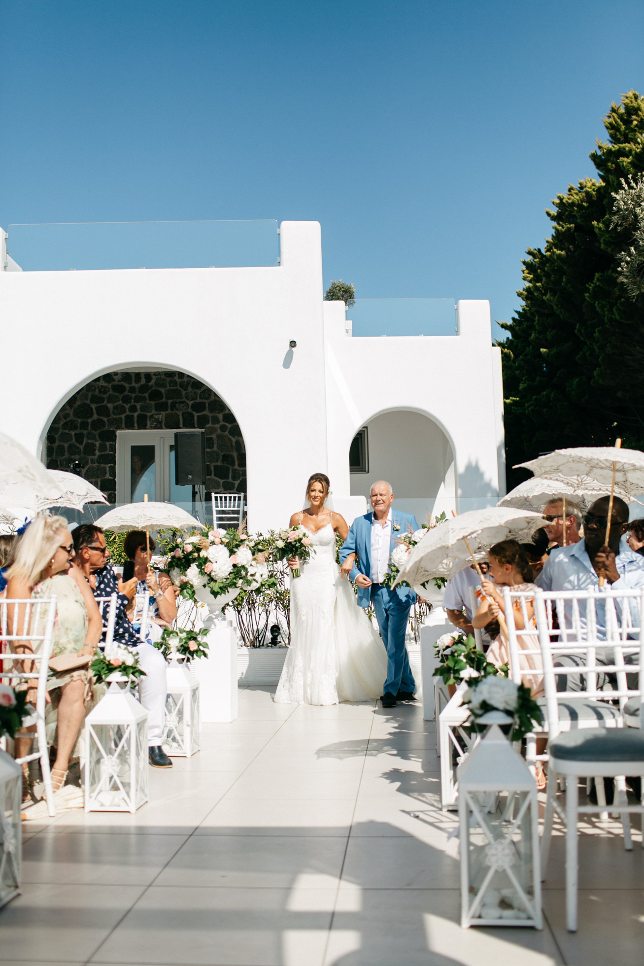 Bride walking down the isle at Le Ciel wedding estate in Santorini island, Greece.