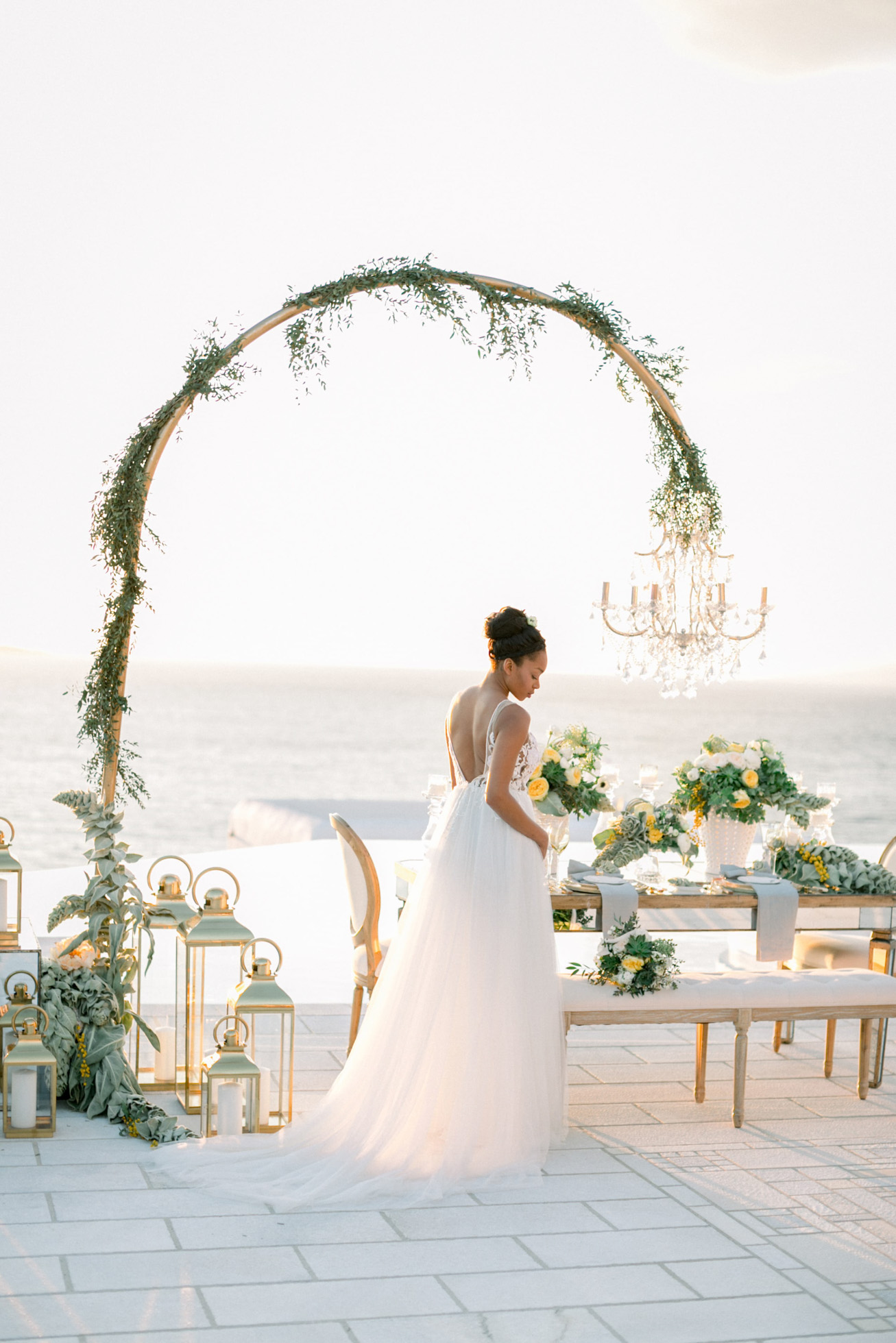 Luxury wedding reception and dinner setup with a bride by DeplanV for a white villa wedding inspiration session in Loyal Villas Luxury, Mykonos, Greece.