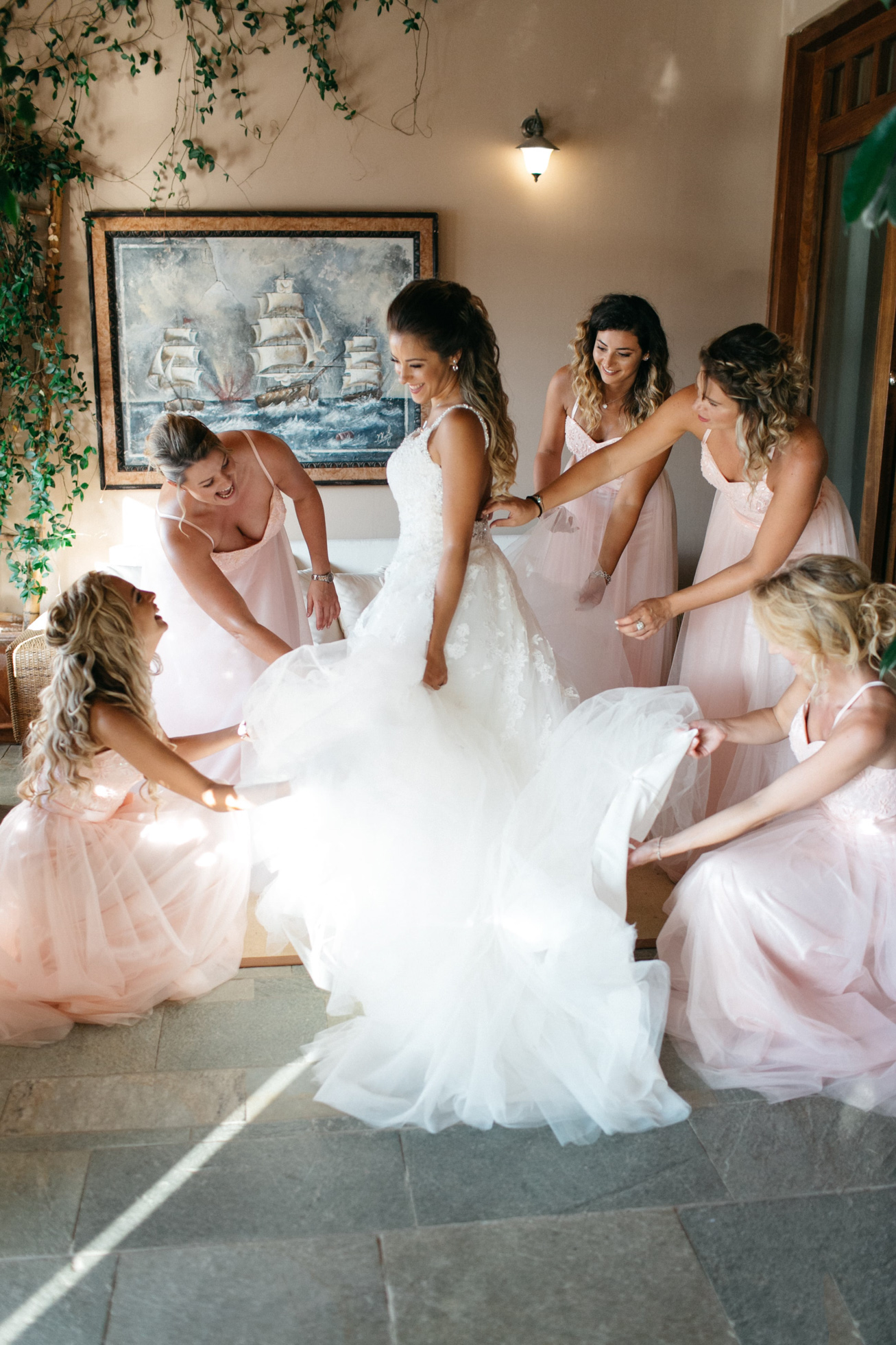 Bride with her bridesmaids during wedding preparations in Chania Crete.