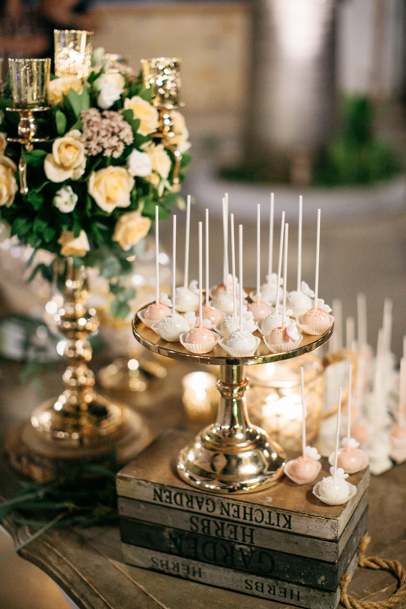 An elegant wedding sweets table with rich florals and intricate details in gold and pink in Chania Crete Greece.