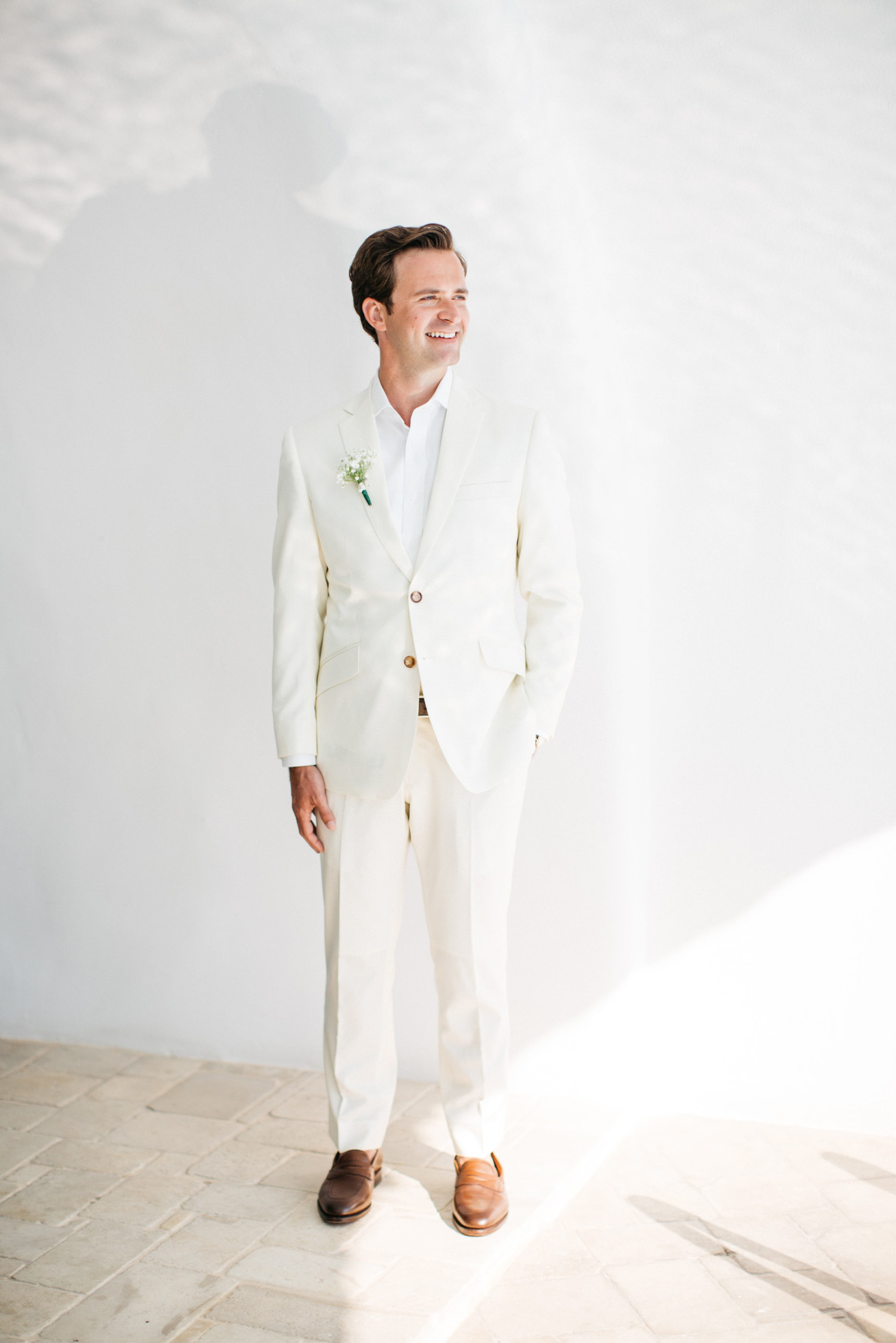Stylish groom getting married in Canaves Suites Oia Santorini.