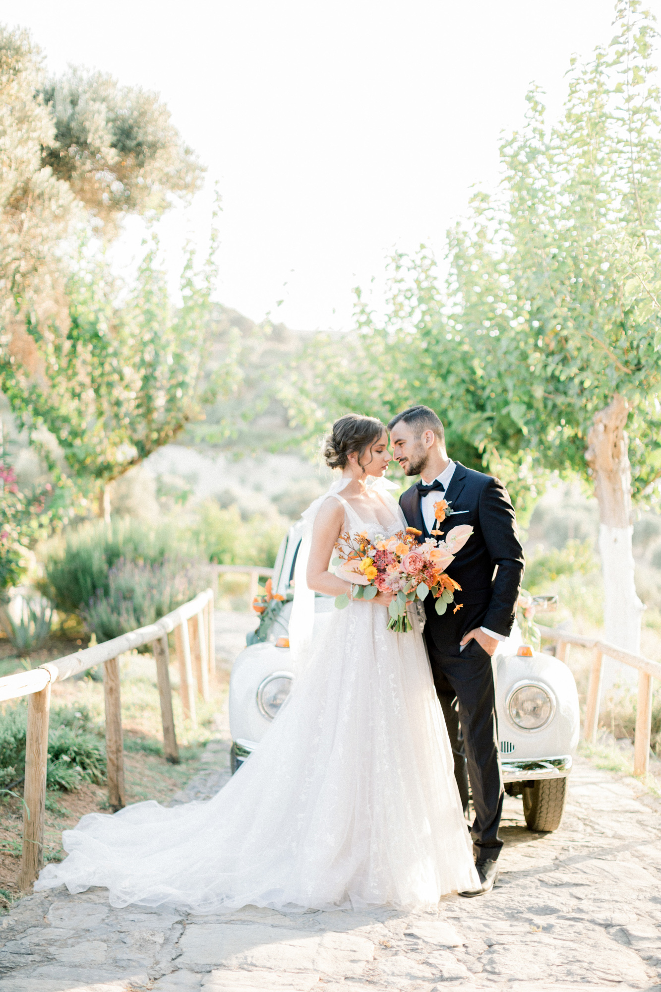 Beautiful bride and groom posing together for a sunset wedding editorial in Grecotel Agreco Farms Crete Greece as published on Ruffled blog.