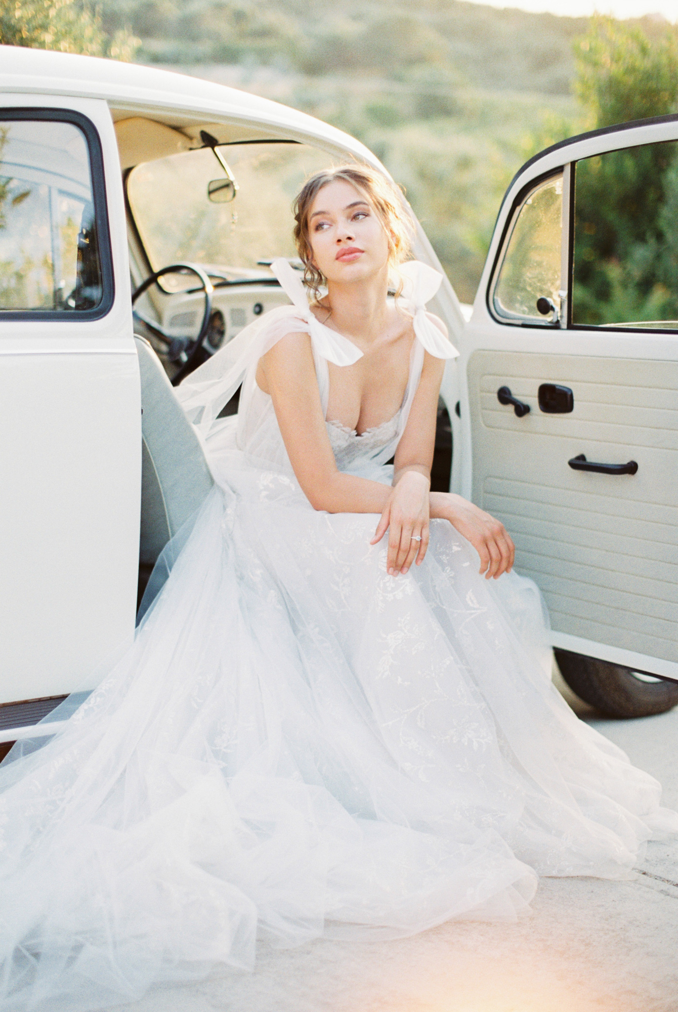 Modern bride in a getaway car at a sunset wedding editorial in Grecotel Agreco Farms Crete Greece as published on Ruffled blog.